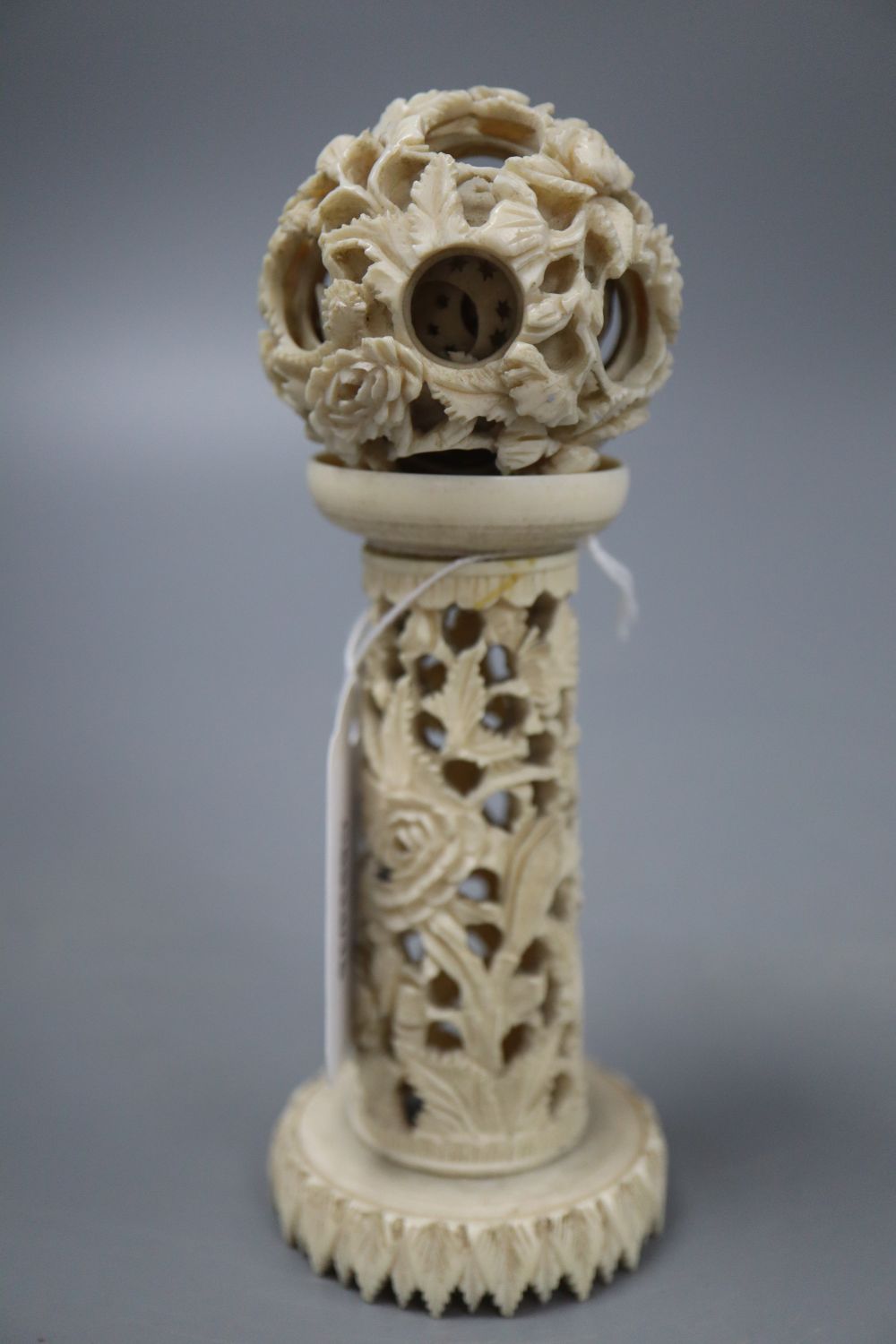 An ivory concentric puzzle ball on stand, overall height 15cm